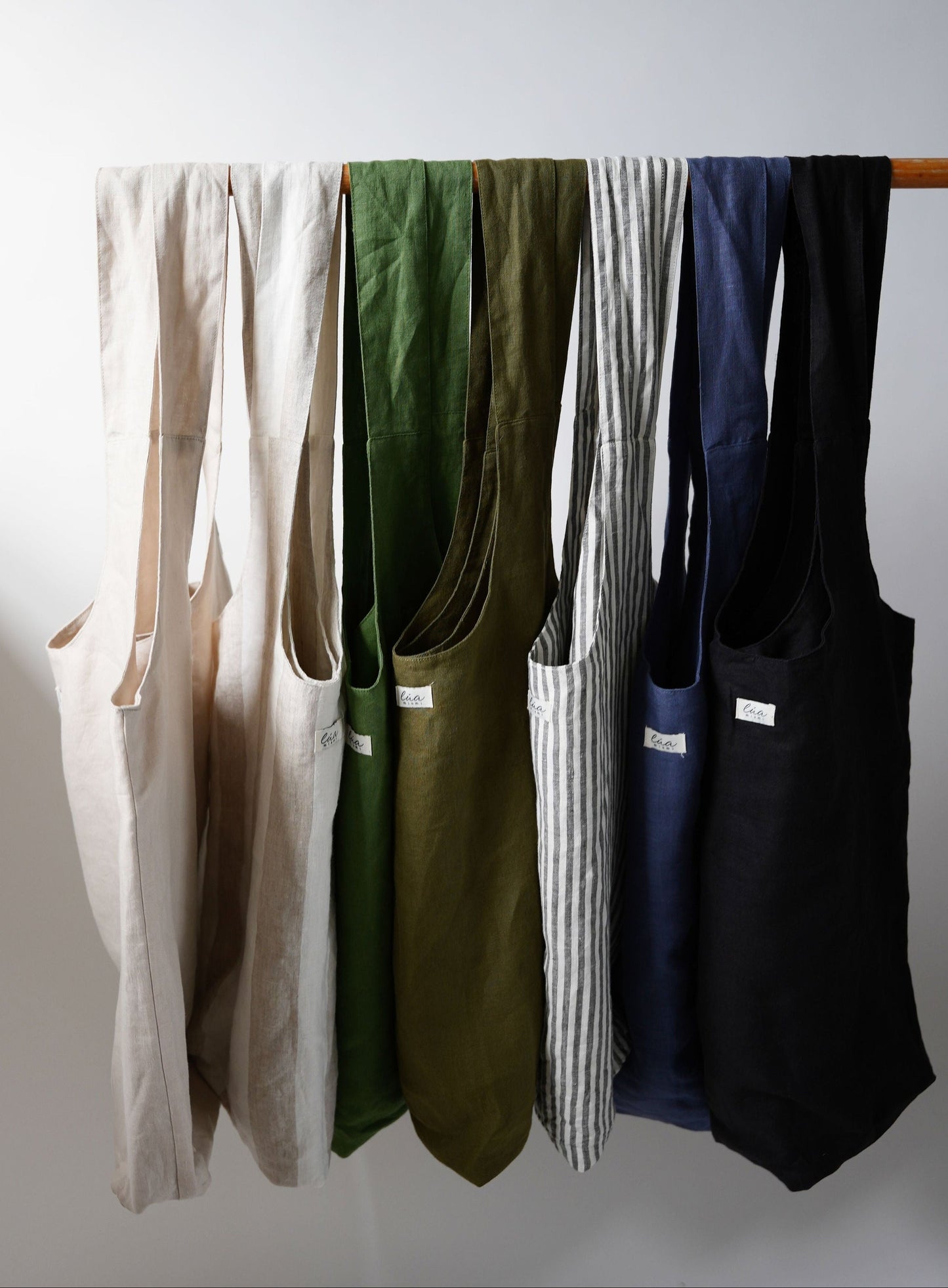 Natural linen tote bags, oversized, multiple colors, Lúa Miami logo detail, white studio background — Lúa Miami