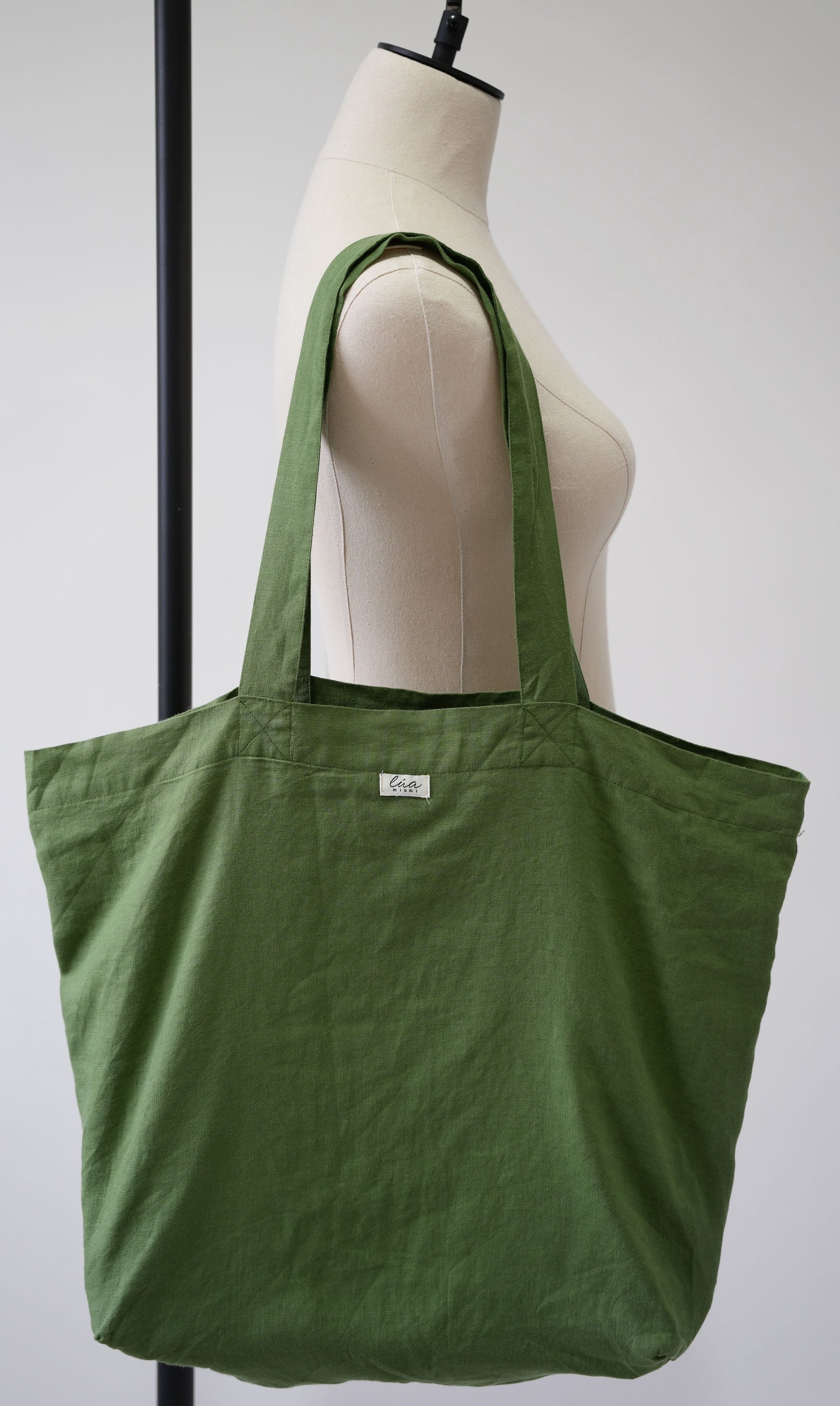 Natural linen tote bag, oversized, green, Lúa Miami logo detail, white studio background — Lúa Miami